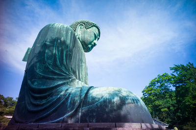 Low angle view of statue against cloudy sky