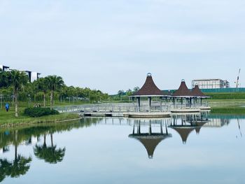 Reflection of building in lake against sky