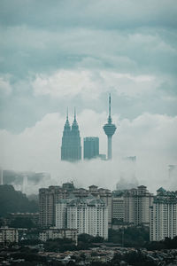 Cityscape against cloudy sky