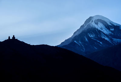 Silhouette mountains against sky during winter