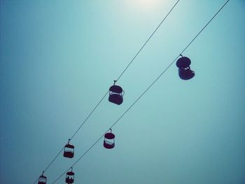 Low angle view of cables against blue sky