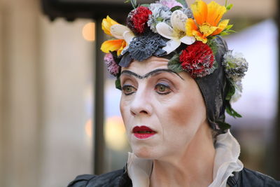 Portrait of woman with red flower