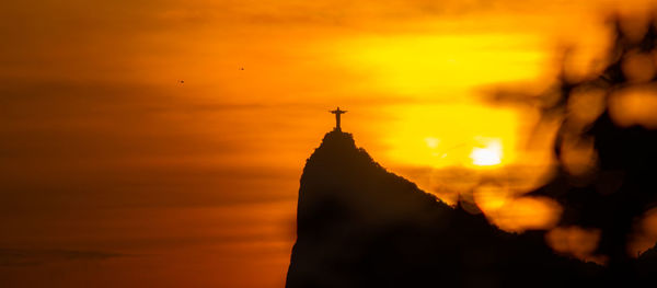 Silhouette of temple against sky during sunset