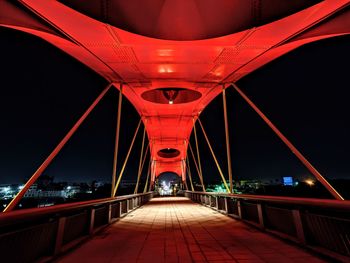 Illuminated footbridge at night