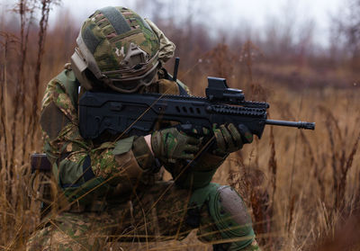 Soldier shoots from a machine gun