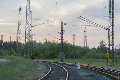 Railroad tracks against cloudy sky