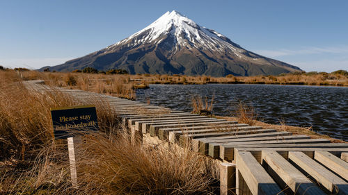 Scenic view of snowcapped mountains by lake against sky