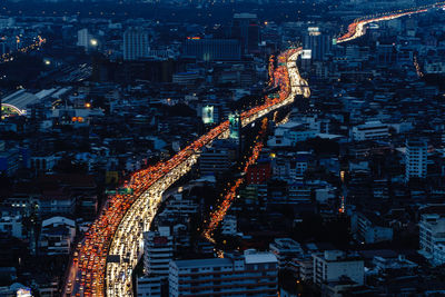 Aerial view of illuminated vehicles on street in city