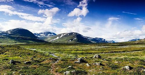 Scenic view of mountains against cloudy sky