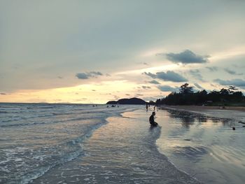 Scenic view of beach against sky during sunset