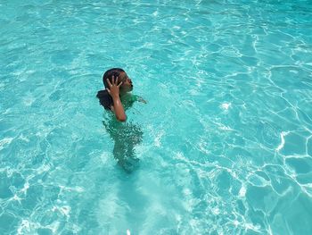 High angle view of girl swimming in pool