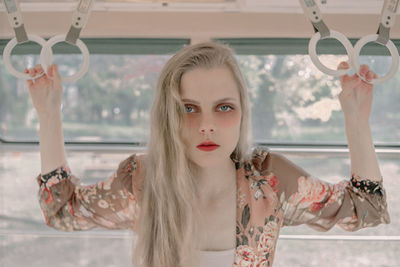 Portrait of woman in front of window