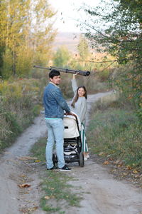 Rear view of couple walking on road