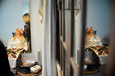 Beautician doing woman make-up at salon