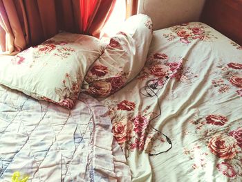 High angle view of headphones on messy bed