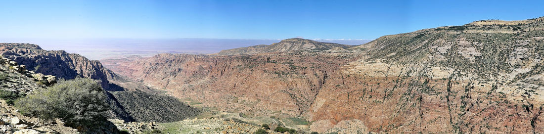 Scenic view of rocky mountains against blue sky