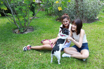 Woman with dog and plants on grass