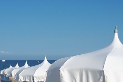 Panoramic shot of white glass against clear blue sky