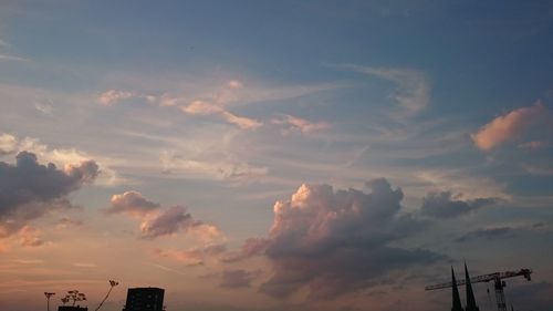 Low angle view of communications tower against sky during sunset