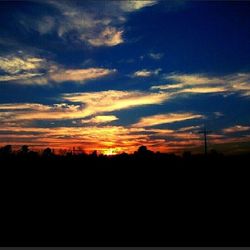 Silhouette of landscape against sky at sunset