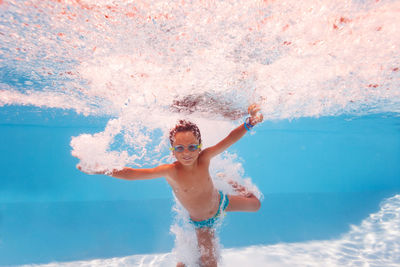 Rear view of woman swimming in sea