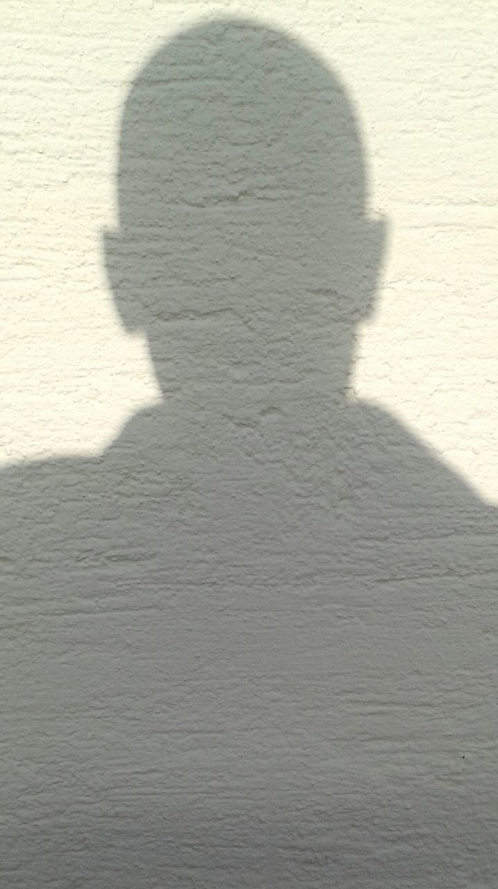 shadow, lifestyles, high angle view, indoors, sunlight, leisure activity, wall - building feature, focus on shadow, standing, unrecognizable person, men, flooring, person, low section, day, street, textured, pattern