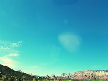 Panoramic view of landscape against blue sky