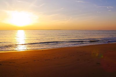 Scenic view of beach against sky during sunset