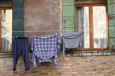 Clothes drying against wall of old building