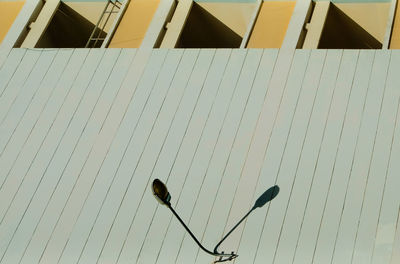 Low angle view of street light against building