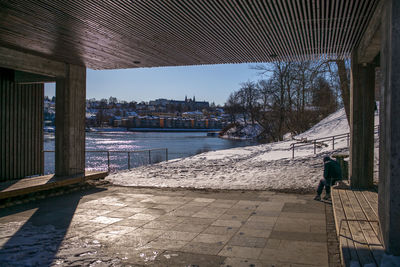 Man walking by water against sky