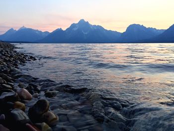 Scenic view of lake against sky during sunset