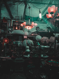 View of illuminated market stall at restaurant