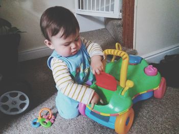 Boy playing with toy at home