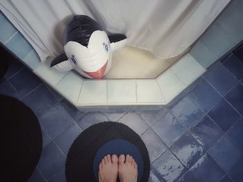 Low section of woman standing by swimming pool