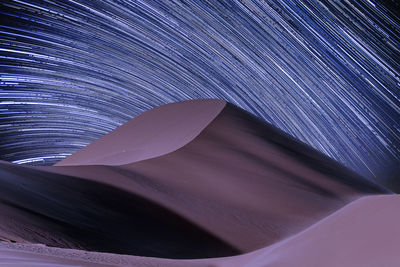 Aerial view of star trails in sky at night