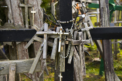 Close-up of rosaries with cross on metal