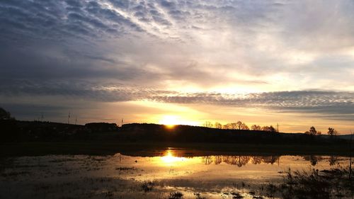 Scenic view of lake against sky during sunset