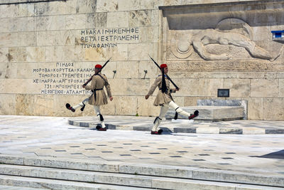 People walking in front of historical building