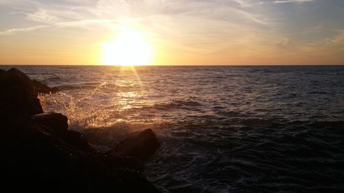 Scenic view of sea at sunset