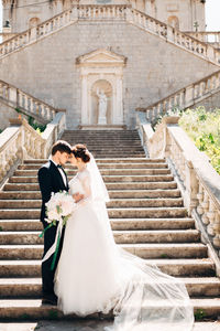 Man and woman standing on staircase of building