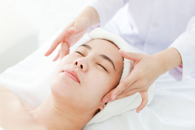 Midsection of woman lying on bed