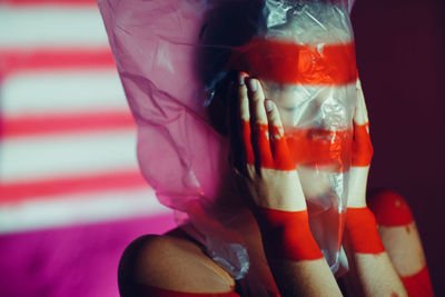 Close-up of hand holding pink glass