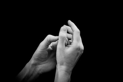 Close-up of woman hand against black background