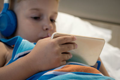 Close-up of boy using mobile phone