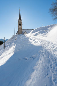 Snow covered building against sky