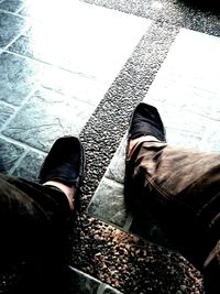 Low section of woman standing on tiled floor