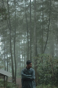 Young man standing in forest