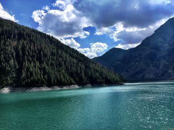 Scenic view of lake and mountains against sky