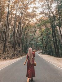 Young woman standing in forest